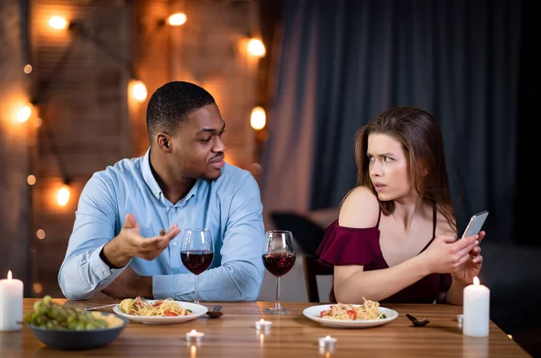 Black Man Angry To His Girlfriend Texting On Smartphone During Date — Stock Fotó