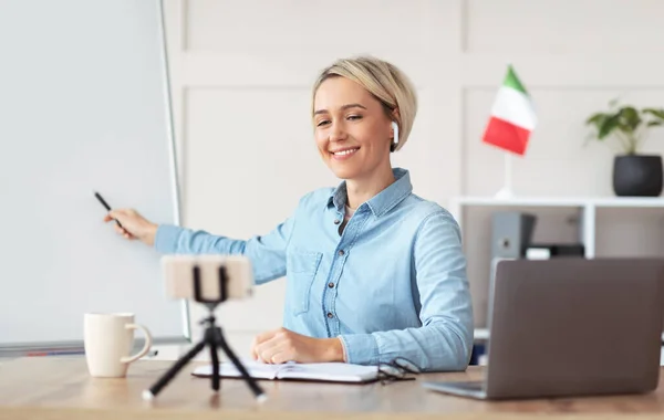 Professional teacher pointing at empty blackboard, giving online lecture or webinar, copy space — Stock Photo, Image