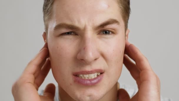 Middle ear inflammation. Close up of young man suffering from ear pain, shouting from ache, slow motion — Stock Video