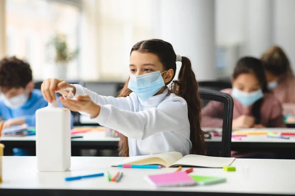 Kislány, aki antibakteriális fertőtlenítőt alkalmaz a kezén — Stock Fotó