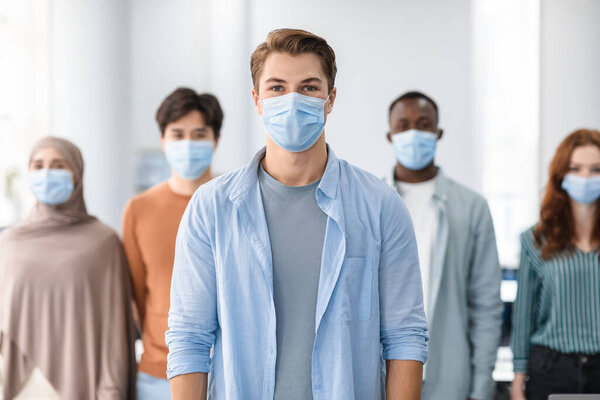 Diverse group of international people wearing medical face masks