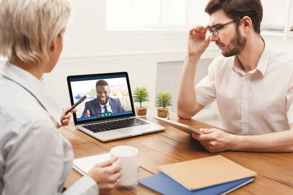 Teleconference Meeting. Black businessman having video call with his business team online