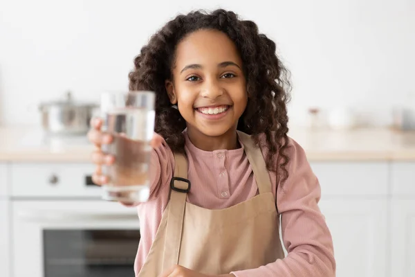 Афро-американская кудрявая девушка с стаканом пресной воды — стоковое фото