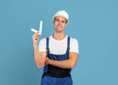 Tulumlu ve kafasında işaret olan yakışıklı işçi.