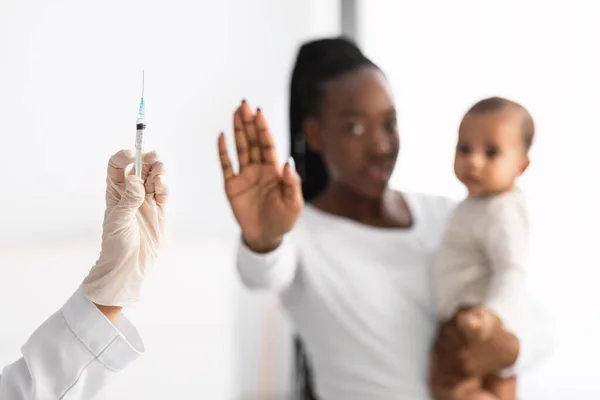 Scared young African American showing stop gesture to syringe — Stock Photo, Image