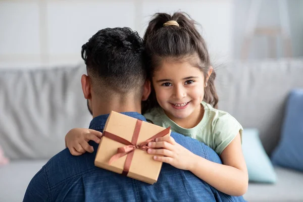Feliz Dia dos Pais. Menina bonito abraçando o pai e segurando caixa de presente — Fotografia de Stock