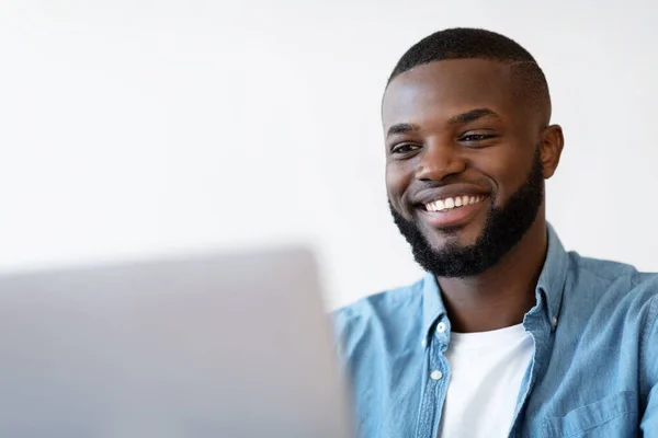 Closeup Shot Of Smiling Young Black Man Using Laptop