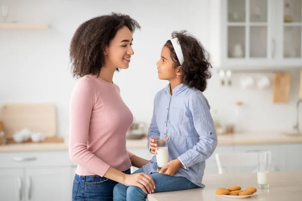 Niña negra y mujer afro bebiendo leche — Foto de Stock