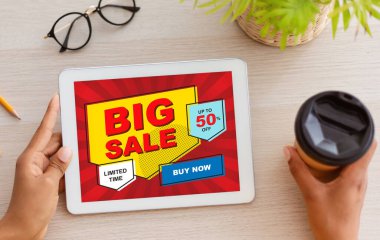 Kişisel tablet kullanan, internetten alışveriş yapan siyah bir kadın.