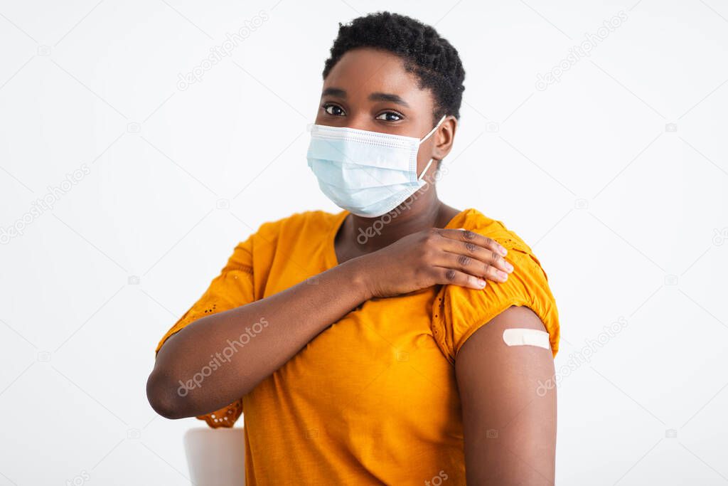 Woman Showing Arm With Plaster After Covid-19 Vaccination, White Background