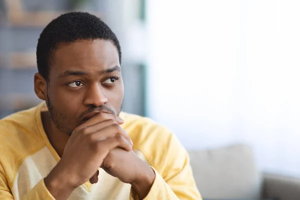Troubled black guy looking at copy space