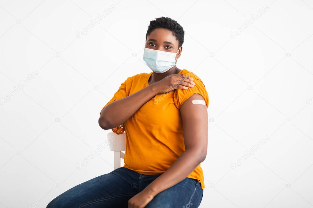 African Lady Showing Arm After Covid-19 Vaccine Injection, White Background