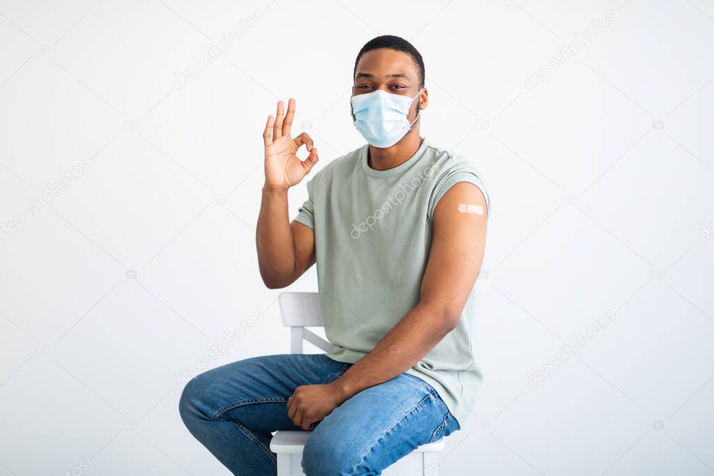 Vaccinated Black Man Gesturing Okay Showing Arm After Injection, Studio
