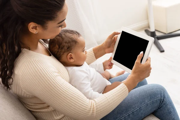 African Mom With Toddler Baby Using Tablet Indoor, Mockup, Side-View