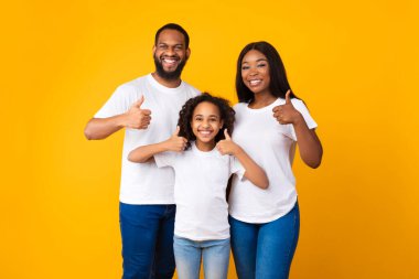 Mutlu siyah aile işaret ediyor ve gülümsüyor.