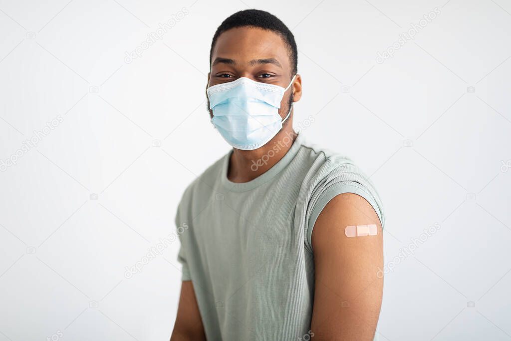 Portrait Of Vaccinated African Guy Wearing Face Mask, White Background