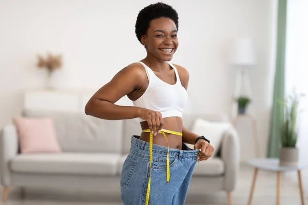 Female Measuring Thin Waist After Slimming Wearing Old Pants Indoor