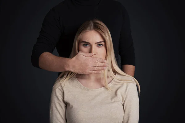 stock image Tyranny, psychological pressure and discrimination concept. Male closes mouth of female