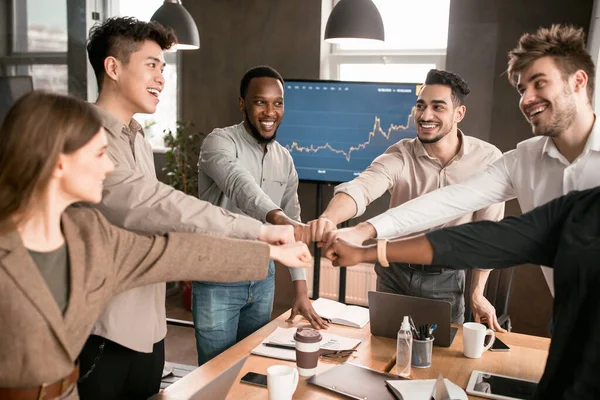 Colleagues Giving High-Five Celebrating Business Success Standing In Office  Stock Photo by ©Milkos 381522740