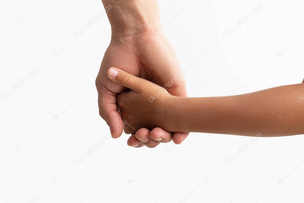 Closeup of father and daughter holding hands