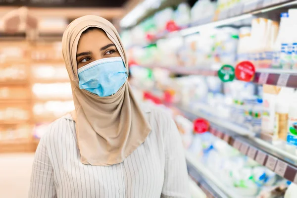 Muslim Lady In Face Mask Doing Grocery Shopping In Supermarket