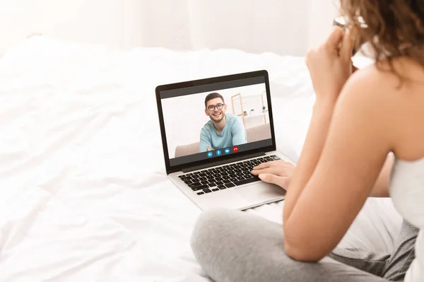 Fjärrkommunikation. Oigenkännlig dam gör videosamtal på laptop till sin pojkvän — Stockfoto