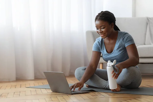 stock image Young Black Woman Choosing Online Tutorials On Laptop For Training At Home