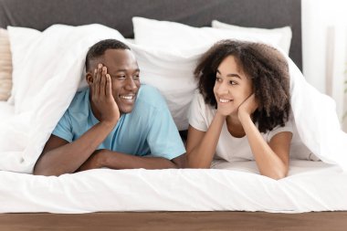 Sevgi dolu genç hipster çifti evde dinleniyor, konuşuyor, dedikodu yapıyor ve romantik bir akşamda dinleniyor.