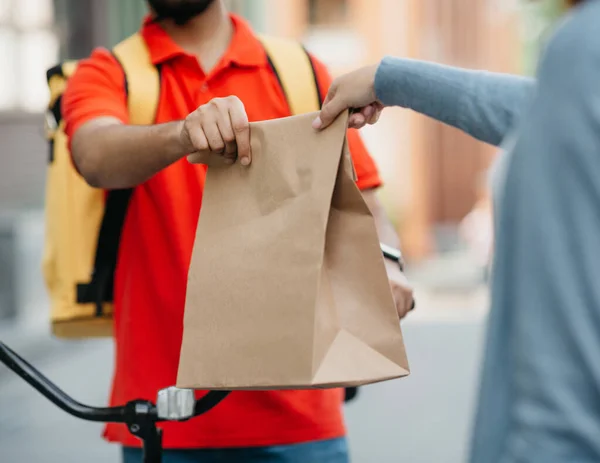 Courier gives fresh lunch to woman, takeaway restaurant food delivery