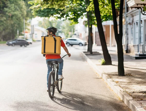 Courier on bicycle with parcel, bike delivery service