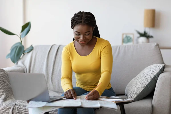 Planning Trip. Happy black woman choosing travel destination on map at home — Stock Photo, Image