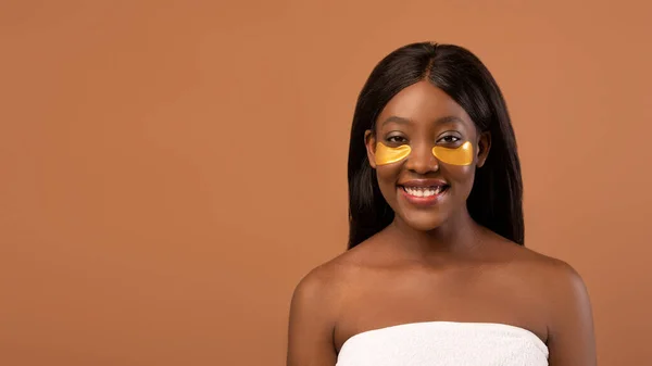 Tersenyum berambut adil african american wanita melakukan perawatan mata — Stok Foto