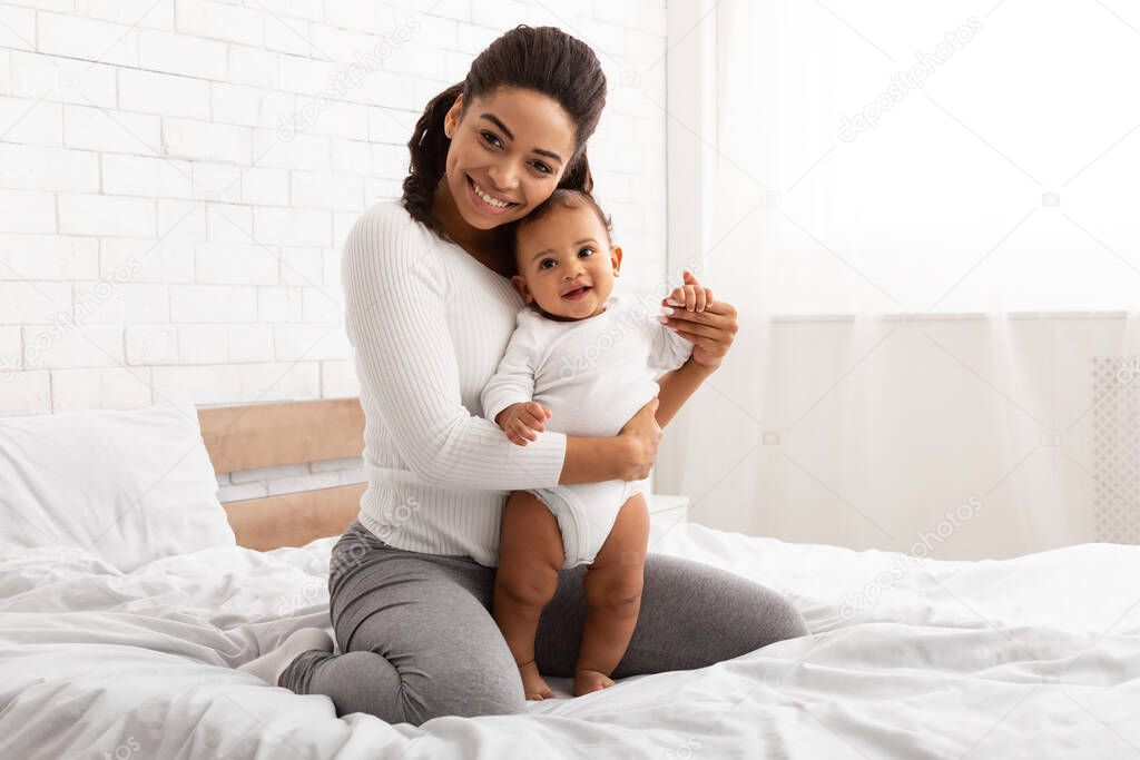 African American Mother Posing With Her Baby Boy At Home