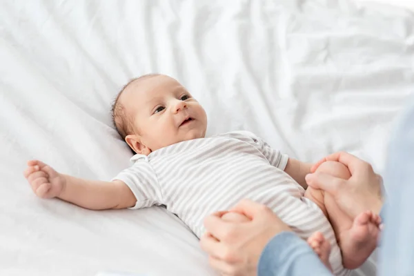 Baby Gymnastics. Unrecognizable Mother Making Streightening Exercises For Newborn Child At Home — Stock Photo, Image