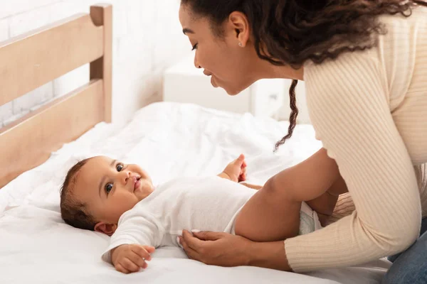 African Mommy Waking Up Baby After Daytime Sleep In Bedroom — Stock Photo, Image