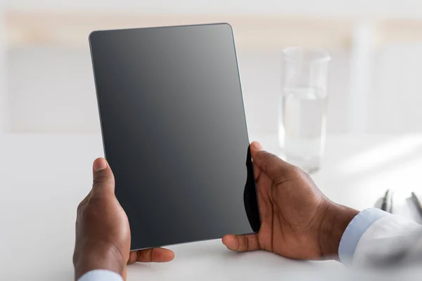 Dokter saran dan teknologi untuk mengobati. Afrika Amerika dokter menggunakan tablet digital dengan layar kosong hitam, mockup untuk iklan — Stok Foto