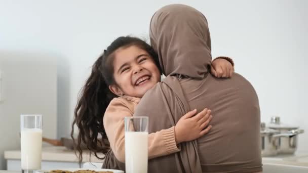 Muslim Mom In Hijab Hugging Little Daughter Duduk di Dapur — Stok Video