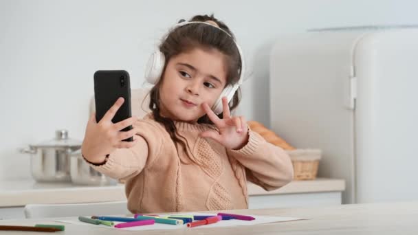 Little Girl Making Selfie On Smartphone Gesturing Thumbs-Up At Home — Stock Video