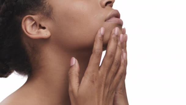 Profile portrait of young african american lady caressing smooth skin of her neck and decollete area, white background — Stock Video