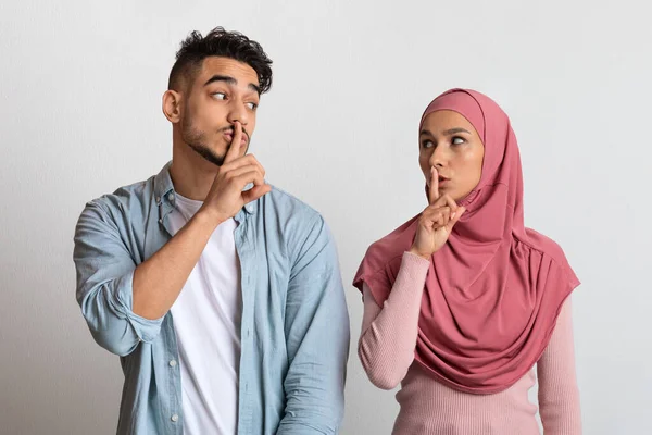 Zeg maar niets. Arabische man en vrouw in hidjab maken stilzwijgen gebaar — Stockfoto