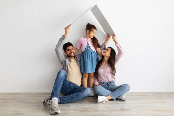 Familie zorg en bescherming concept. Oosterse ouders maken symbolisch dak van handen boven hun dochtertje — Stockfoto