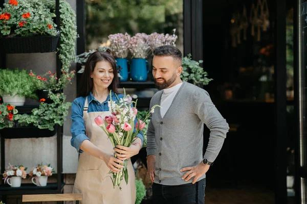 Small business and commerce, florist make bouquet for client outdoor