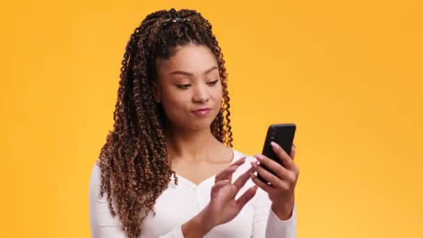 Νεαρή αφροαμερικανή γυναίκα με αφρο χτένισμα βίντεο συνομιλίας με φίλους, χαιρετώντας το χέρι στο smartphone και μιλώντας — Αρχείο Βίντεο