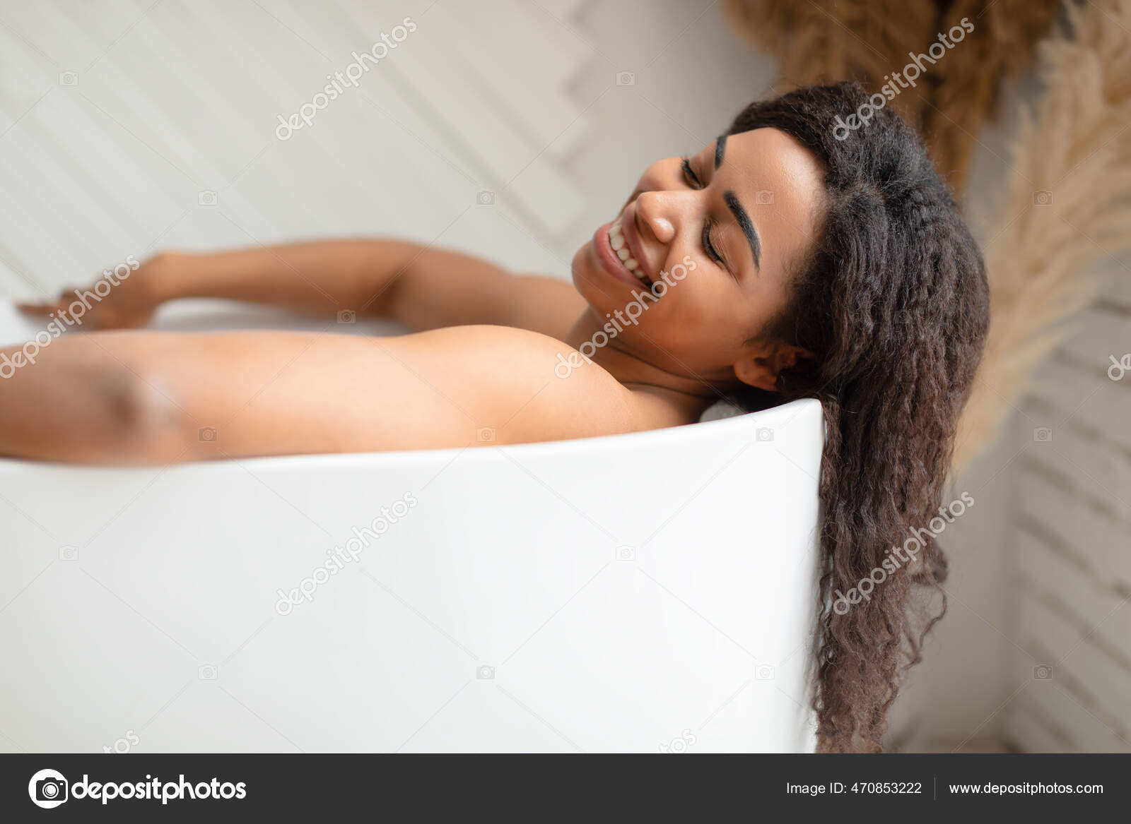 Black Woman Taking Bath Relaxing Lying In Bathtub In Bathroom Stock Photo  by ©Milkos 470853222