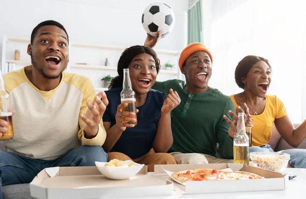 Emotional african american friends watching football match together — Stock Photo, Image