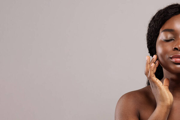 Skin Care Treatments. Half Portrait Of Beautiful Naked Black Lady Touching Face