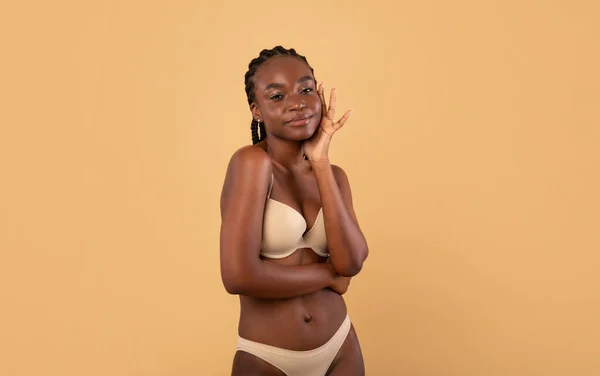 Black woman, underwear model and smile in fashion studio, beauty or body  care by white background. Happy african woman, lingerie or bikini body,  cosmetics or skin wellness with confidence and proud