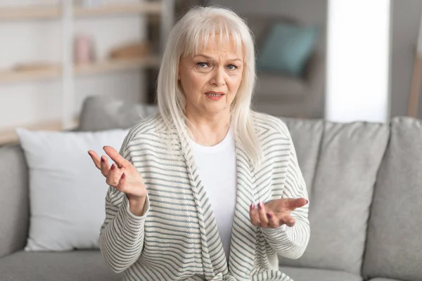 Mulher madura falando na câmera e gesticulando — Fotografia de Stock