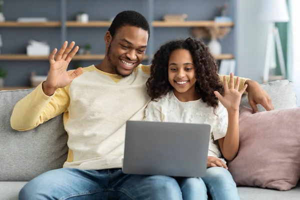 Black father and daughter having video conference from home — Stock Photo, Image