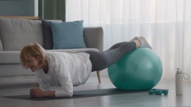 Üst düzey kadın, İsviçre Balosu 'yla kalas egzersizi yapıyor.